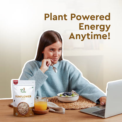 Woman sitting at a table with a laptop, sunflower seed package, and bowl of fruit, with text 'Plant Powered Energy Anytime!'.